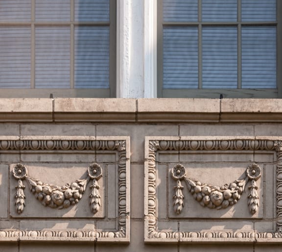 a building with two balconies with symbols of two bulls on it