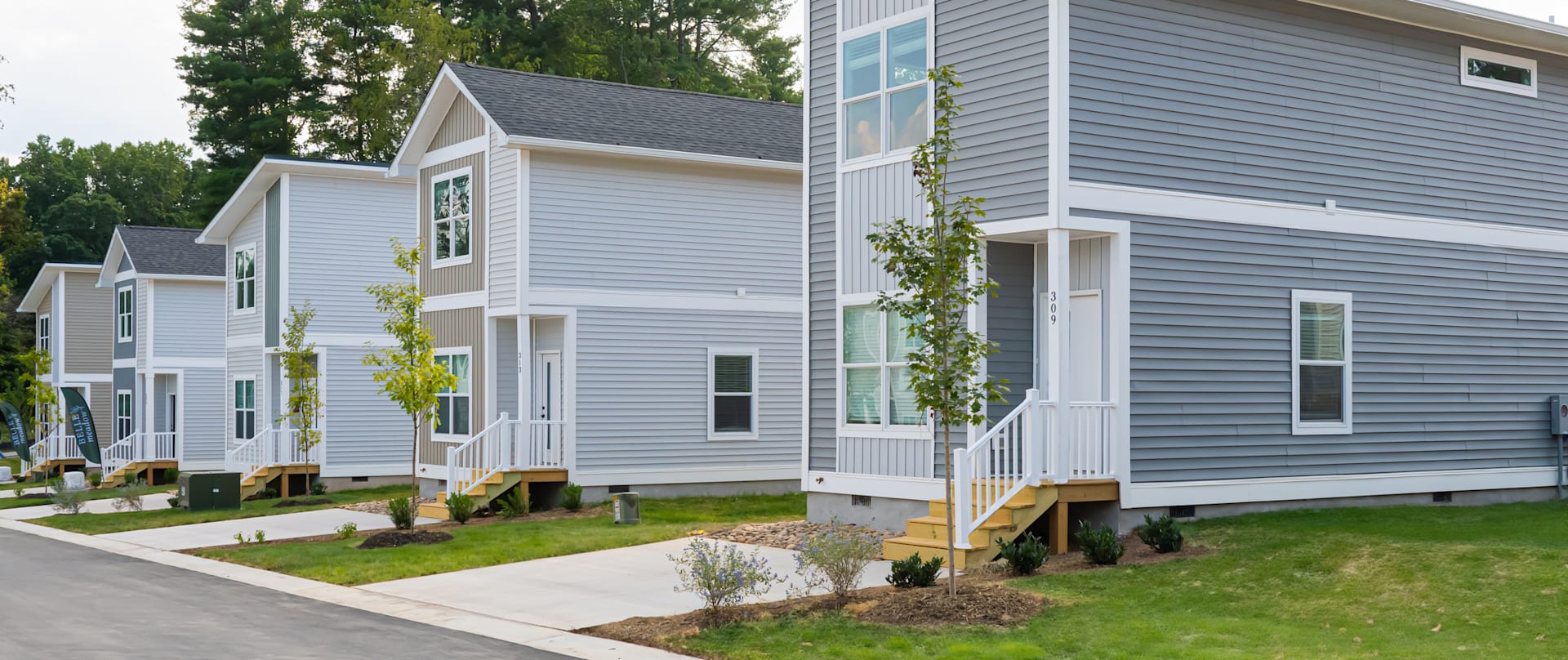 Belle Meadow rental homes in Asheville featuring modern two-story residences with private entrances and landscaped walkways.