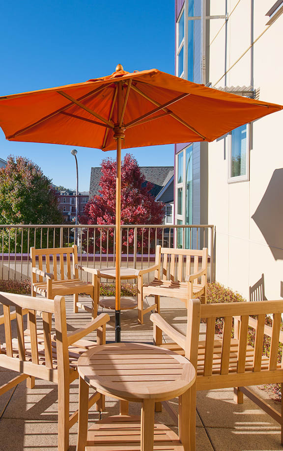 a Clubhouse lobby with a fireplace and a table with chairs with a stone kitchen island