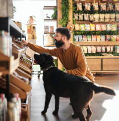 a man and his dog looking at food in a grocery store at North Grove, Riverside, 92501