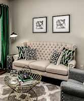 A living room with a white sofa and a coffee table.