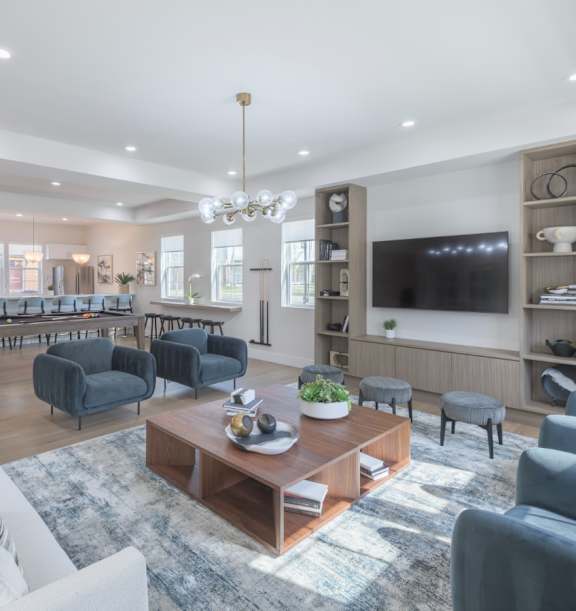 A living room with a large blue sofa and a coffee table.
