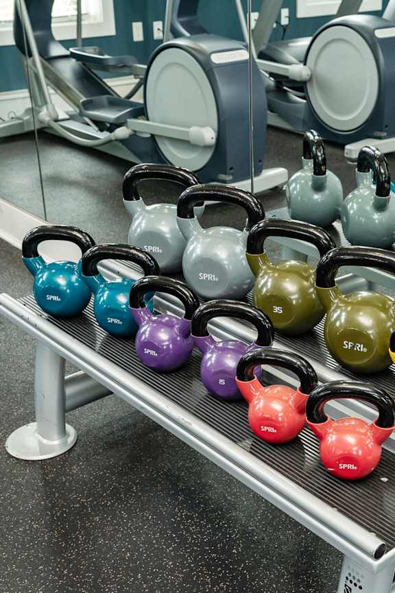 a gym with cardio equipment and weights at the gateway apartments at Concord Ridge Apartments, Concord, NC, 28027