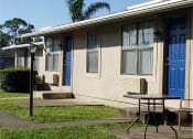 Thumbnail 4 of 21 - a house with a blue door and a table in front of it