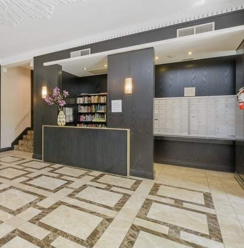 a lobby with a reception desk and a chandelier