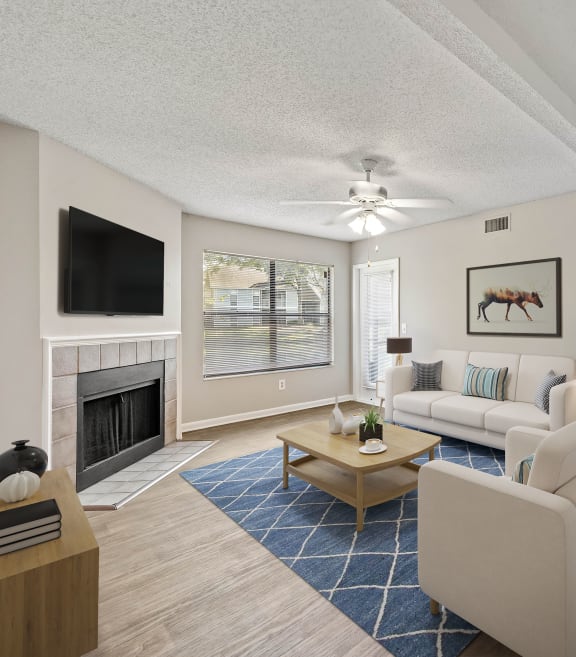 a living room filled with furniture and a large window