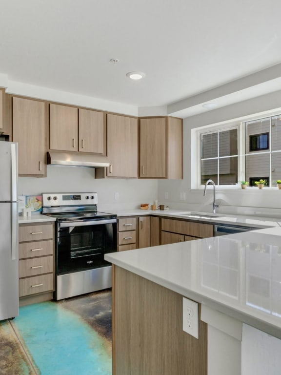 a white kitchen with wooden cabinets and stainless steel appliances