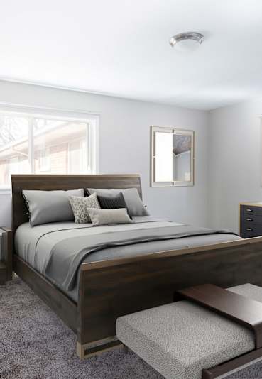 A bedroom with a large bed and a bench. at Oak Park Gardens, Oak Park, 48237