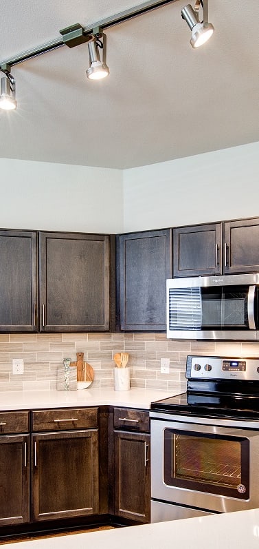 a kitchen with stainless steel appliances and a white counter top