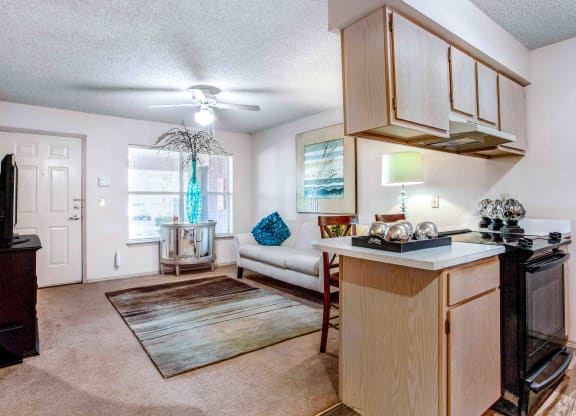 an open living room and kitchen with a couch and a table
