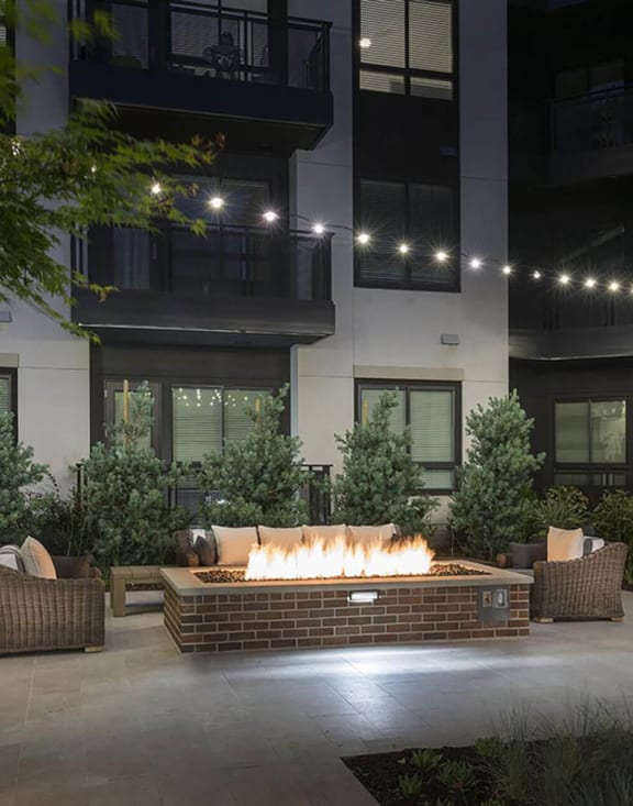 a fire pit in the courtyard of an apartment building