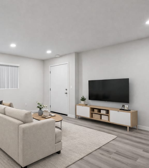 A living room with a couch, chair, and television.