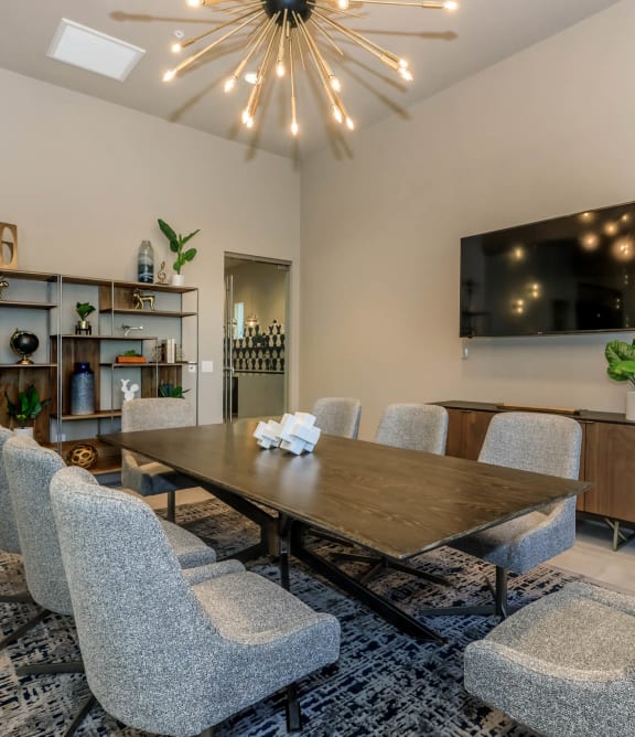 a dining room with a table and chairs and a tv