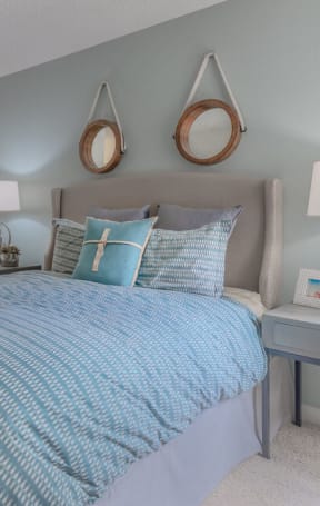 a bedroom with a bed and lamps and a mirror at City View Apartments at Warner Center, Woodland Hills, CA
