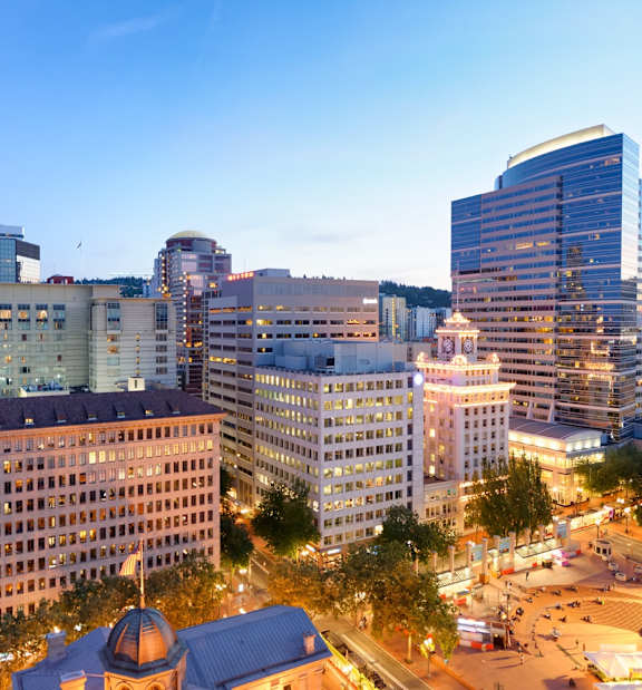 A cityscape with buildings and a dome structure.