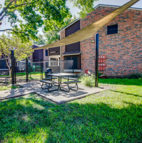 our apartments have a spacious patio with a picnic table at Timberglen Apartments, Texas, 75287
