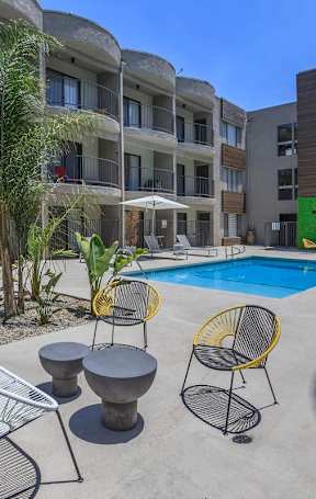 A room with wooden floors and a bench. at Lafayette Apartments, Los Angeles 90019