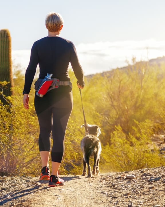 Woman on Hike with Small Dog