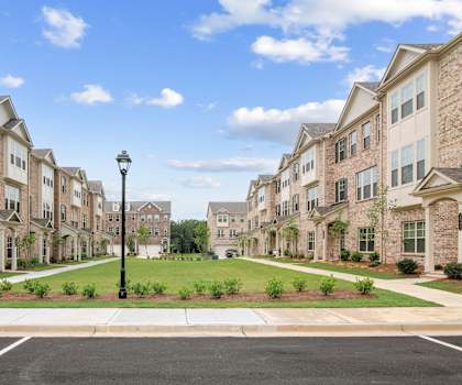 an empty parking lot in front of an apartment building