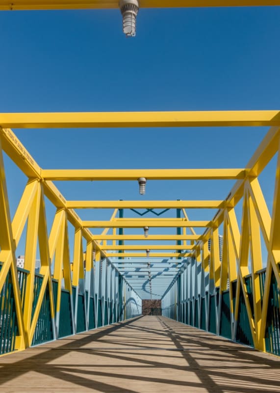 a yellow bridge with a blue sky in the background at The Park Apartments in Minneapolis, MN