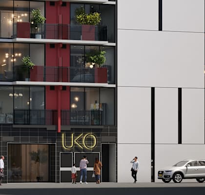 A modern building with a red stripe on the side and the word "UKO" on the front.