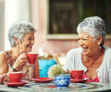 Elderly women sharing a hot beverage