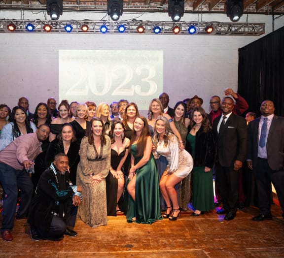 a group of people posing for a photo at a party