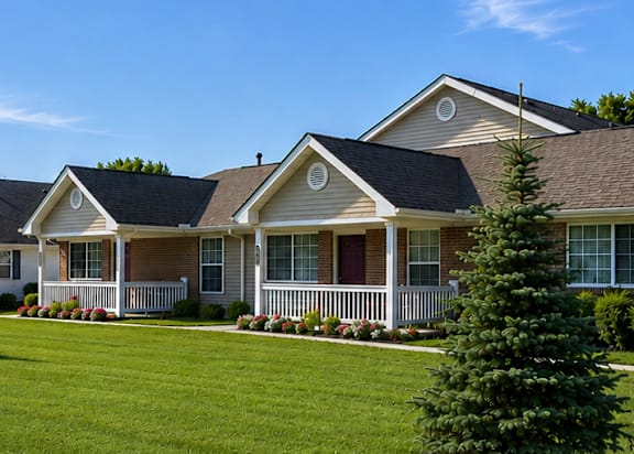 A row of houses with green lawns in front.