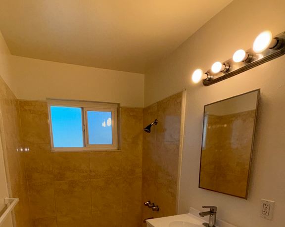 A bathroom with a window and a sink.