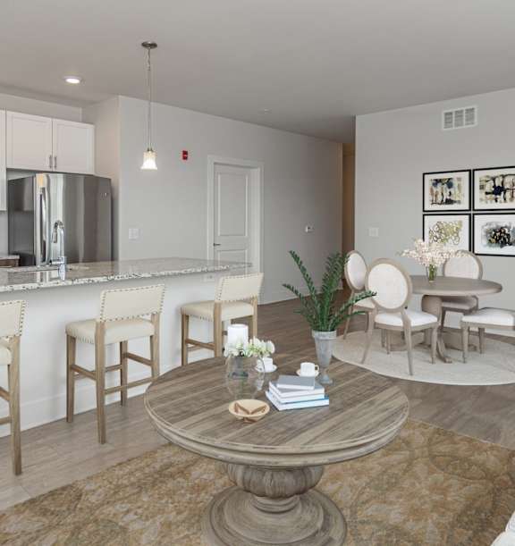 A modern kitchen with a dining table and chairs.
