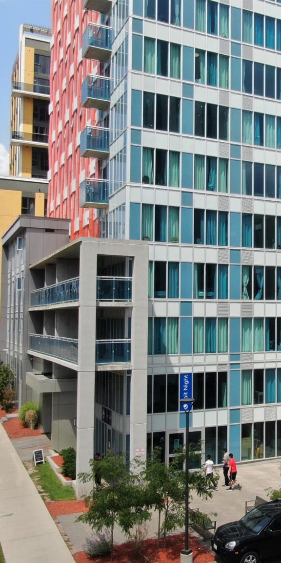 an aerial view of two modern buildings on a city street