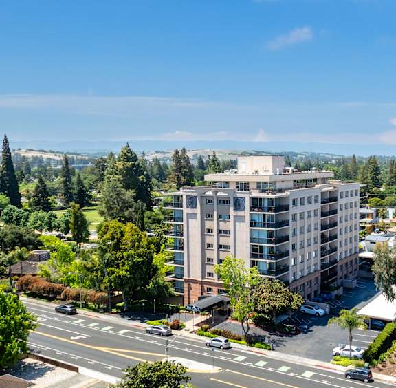 A large building with a parking lot in front of it.