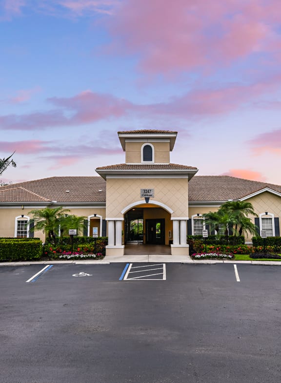 a mansion with a parking lot in front of it