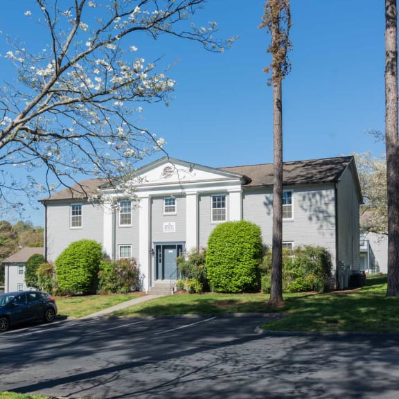 a white house with a car parked in front of it