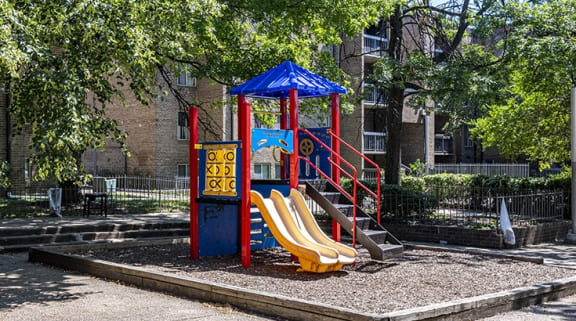 a playground with a swing set and a slide