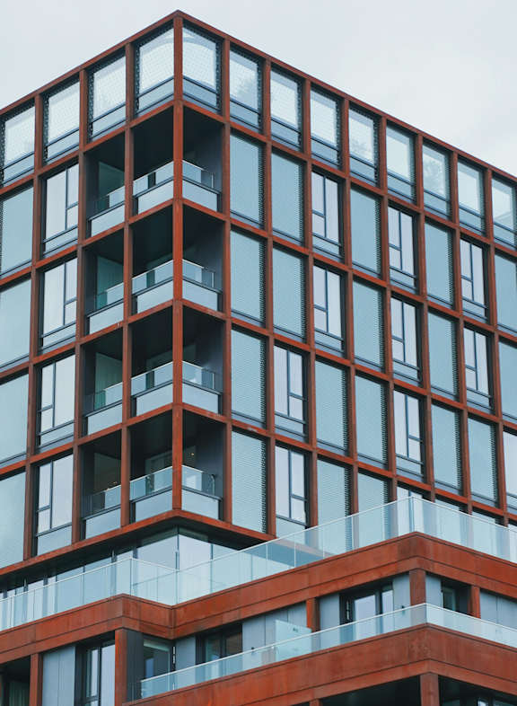 A tall building with many windows and balconies.