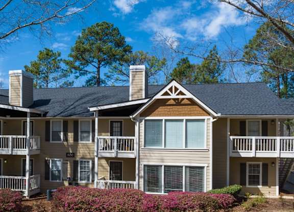 Exterior view of apartment building, trees and landscaping at Summerchase at Riverchase in Hoover, Alabama