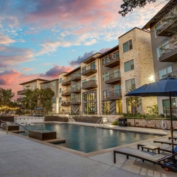 Astra Avery Ranch Pool with Lounge Chairs at Dusk