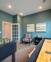 a game room with a foosball table and a pool table