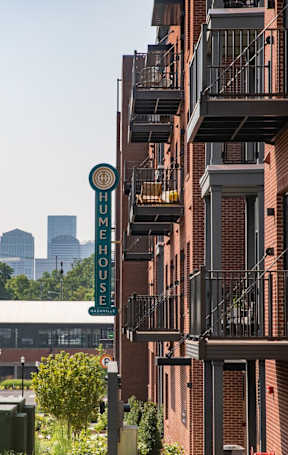 A street view of a city with a building in the background.