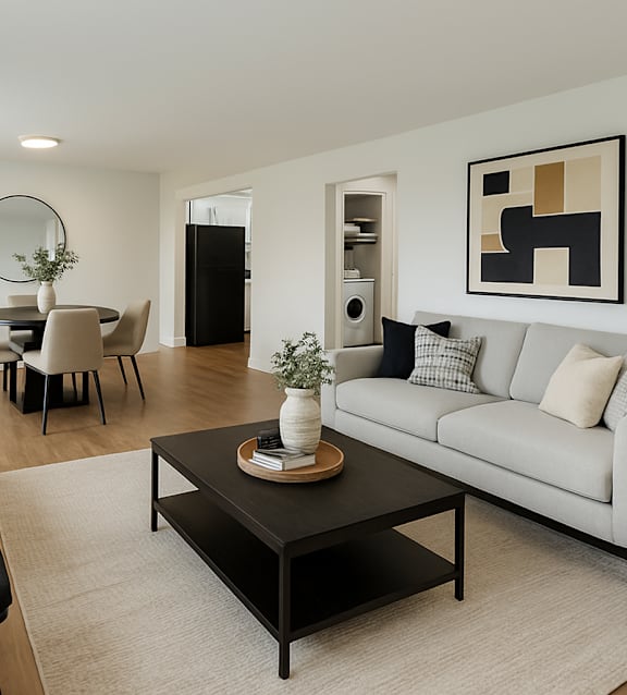 A modern living room with a black chair and a white couch.