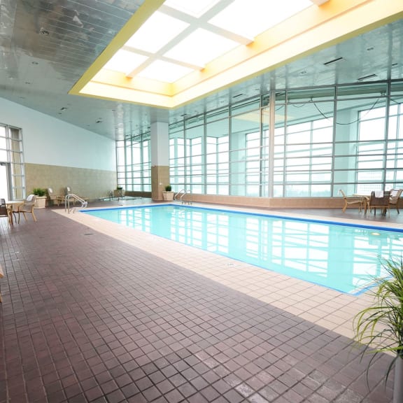a swimming pool in a large building with windows