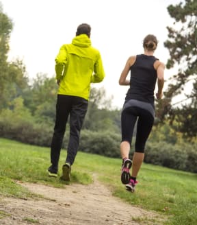 Two people jogging on an outdoor trail