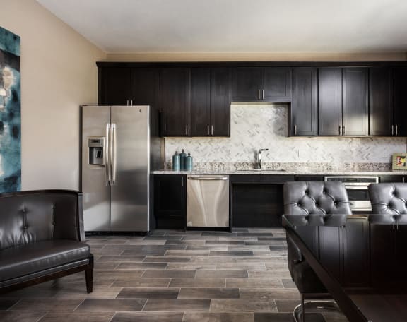 a kitchen with black cabinets and a stainless steel refrigerator at The Avenue at Polaris Apartments, Columbus, OH