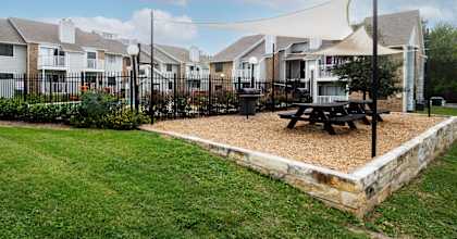 A row of houses with a picnic table in front.