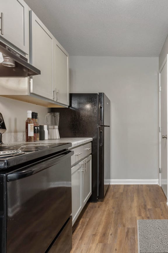 a kitchen with stainless steel appliances and white cabinets