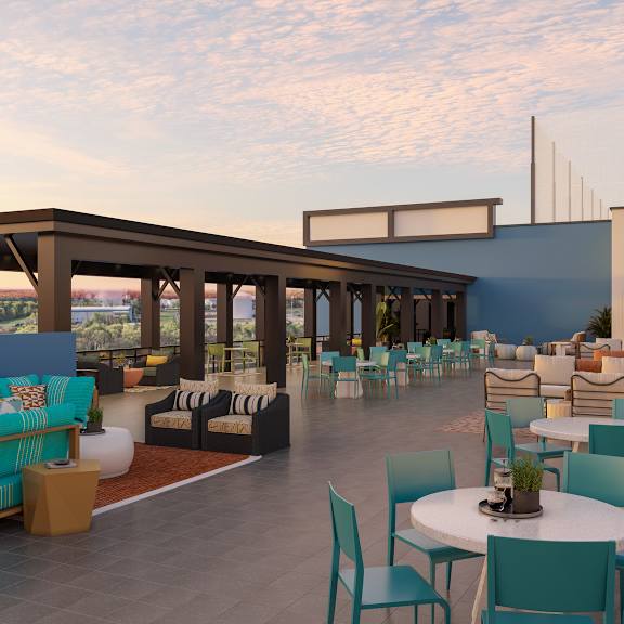 A patio with a table and chairs is set up on a rooftop.