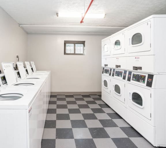 a washer and dryer laundry room with a checkered floor