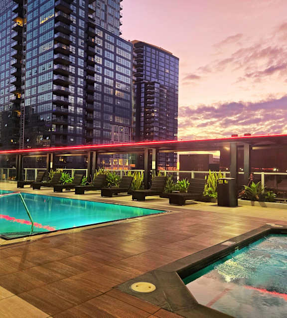 A swimming pool with lounge chairs and the word "REACH" repeated across the image.
