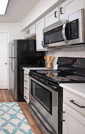 Renovated Kitchen with Stainless Steel Appliances and Quartz Countertops